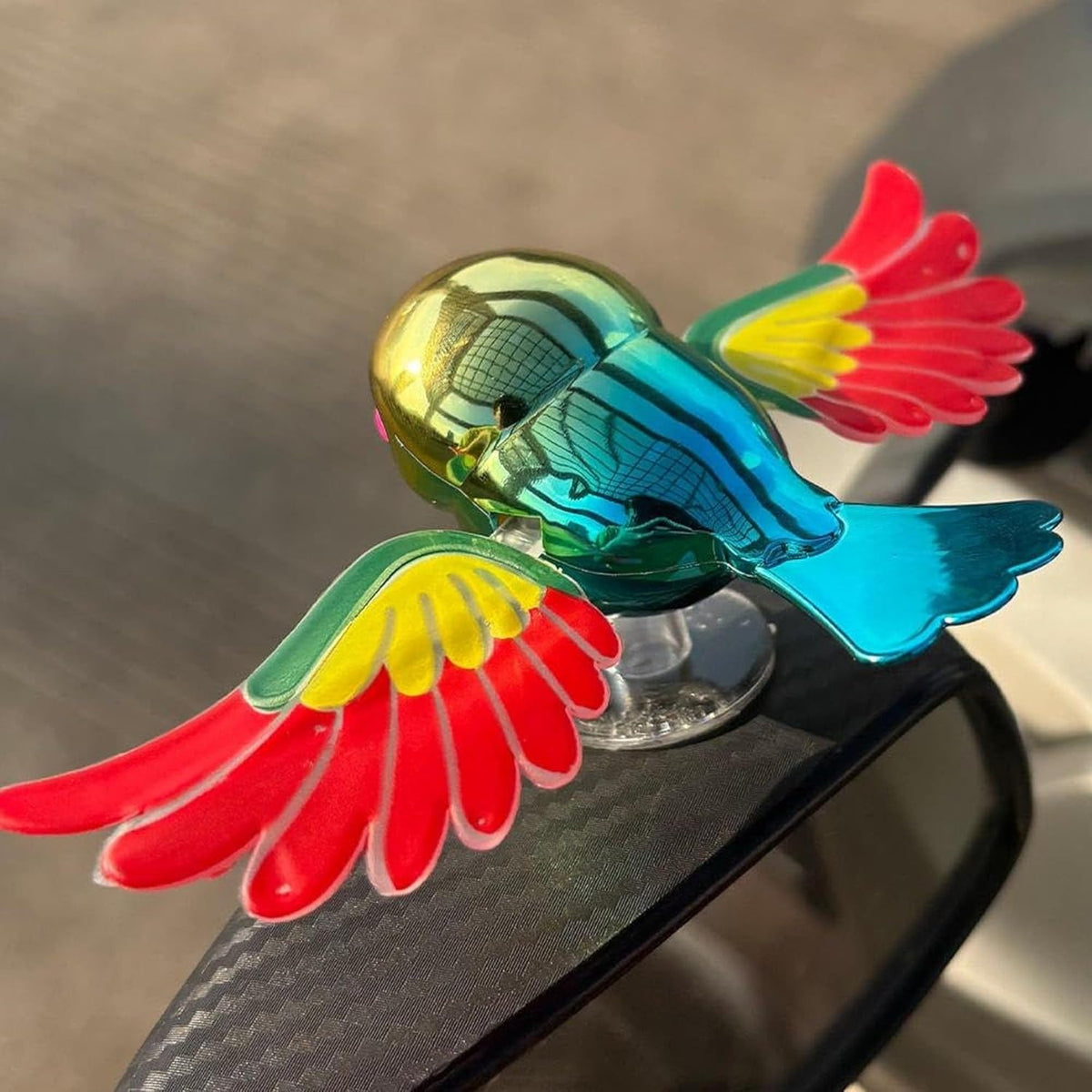 Car Dashboard Bird Toy with Rotating Wings and Suction Base in multicolor
